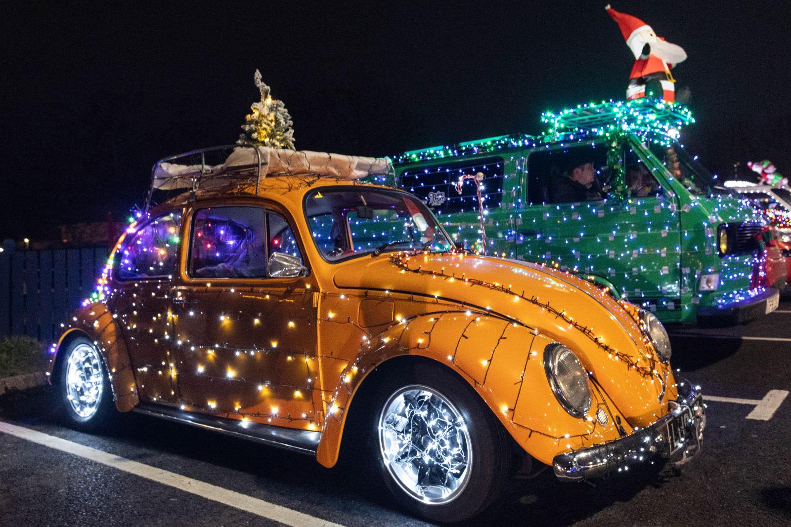 A yellow VW Beetle dressed in Christmas lights for the annual Vee Dubs Christmas Cruz in Weston-super-Mare